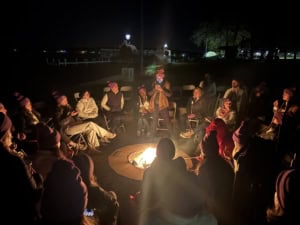 Scholars around a camp fire